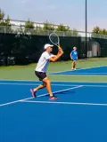 Man returning the shot on tennis court.