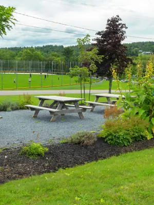 Picnic tables and bbq area outside.