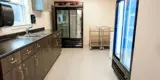 Bar area with counters, commercial fridges.