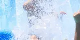 Child splashing down from slide.
