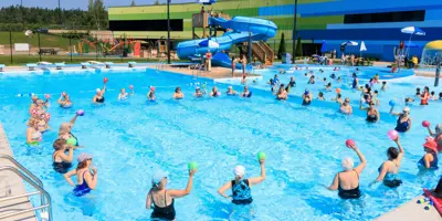 Group of women doing exercises in pool.